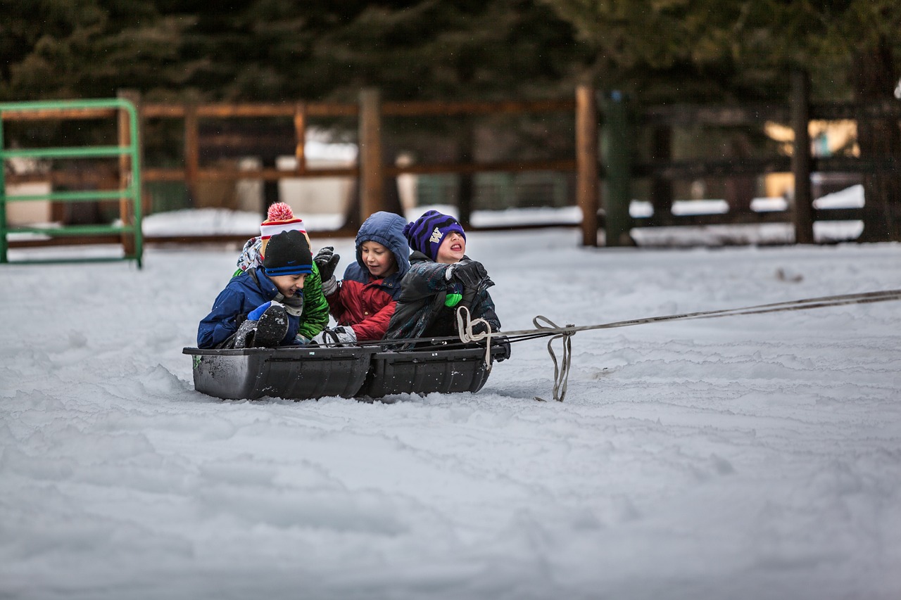 Children playing in the snow at dusk
