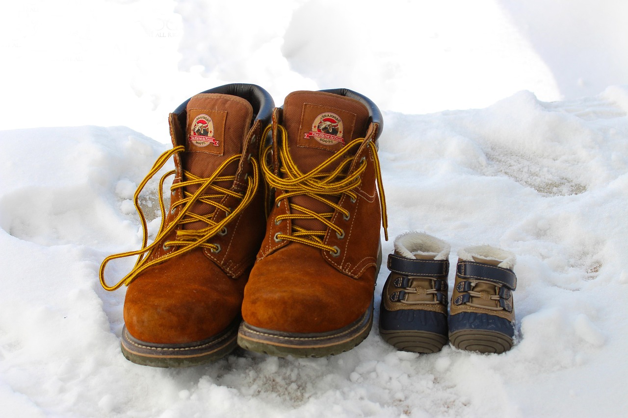 Pair of brown leather winter boots standing in the snow