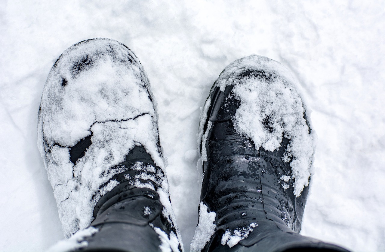Winter boots standing on a snowy, icy surface