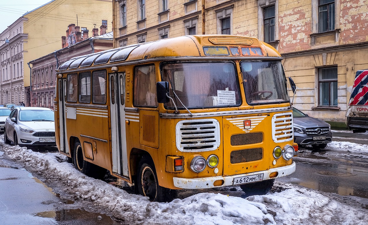 City bus driving down a snow-covered street in winter